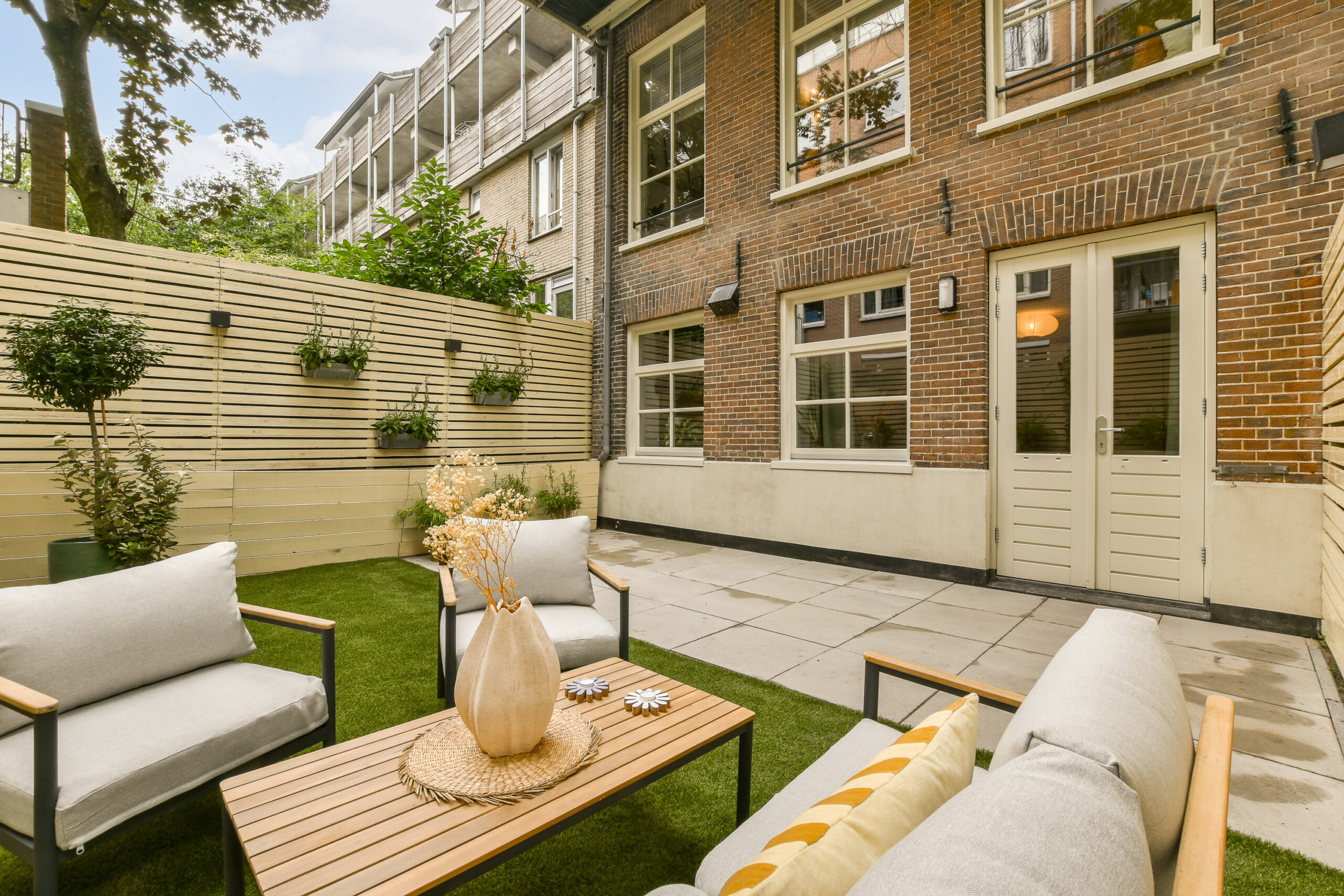 the-backyard-has-a-patio-with-chairs-and-a-table-2025-02-10-00-45-11-utc