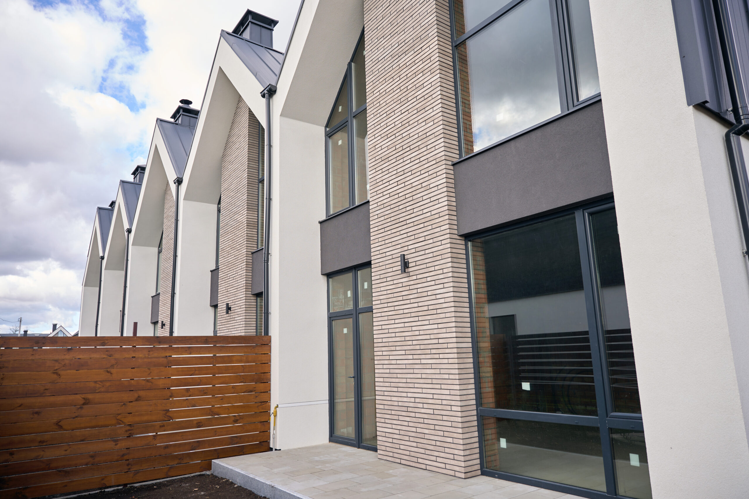 Two storey townhouses lined up next to another